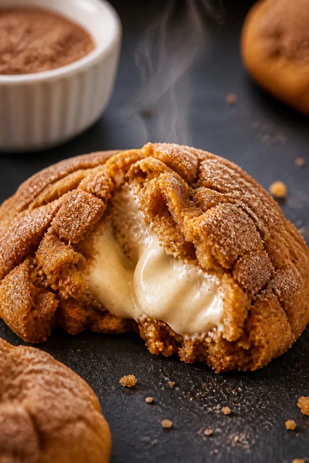 Close-up detail: A freshly baked Pumpkin Cheesecake Cookie torn open to reveal the silky, tangy crea