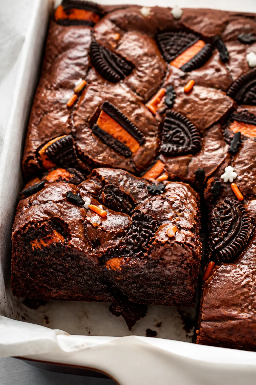 Close-up detail of freshly baked Halloween Oreo Brownies still in the parchment-lined square pan, ed