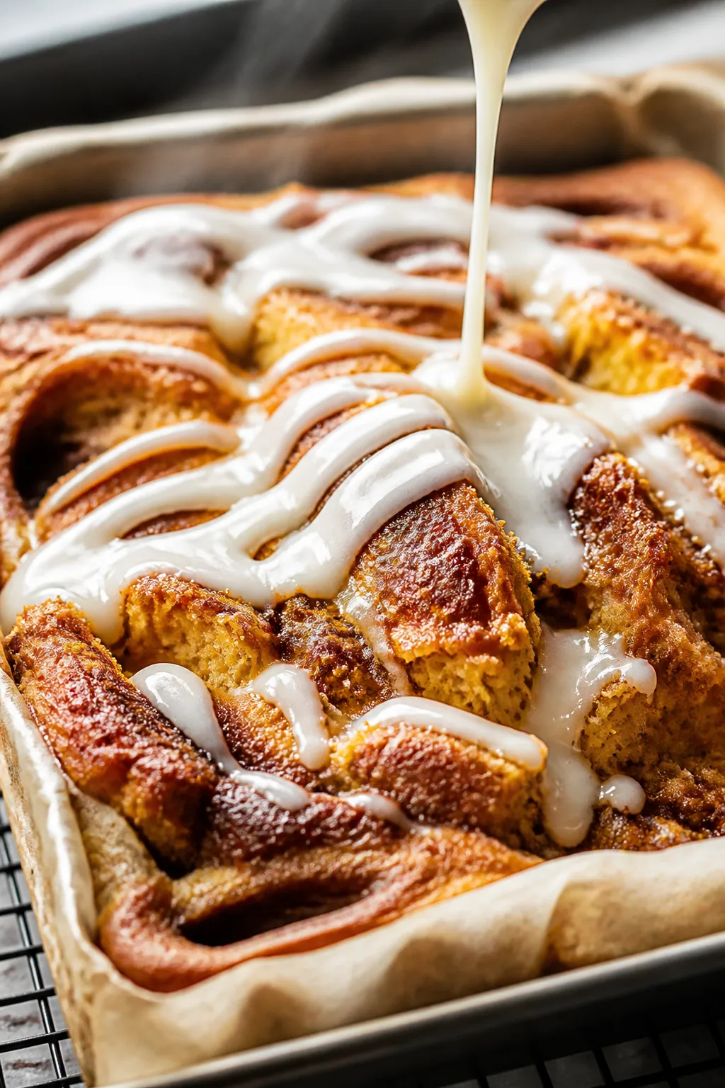 Close-up detail shot: A just-baked Pumpkin Cinnamon Roll Cake in a 9x13 pan, golden edges slightly p