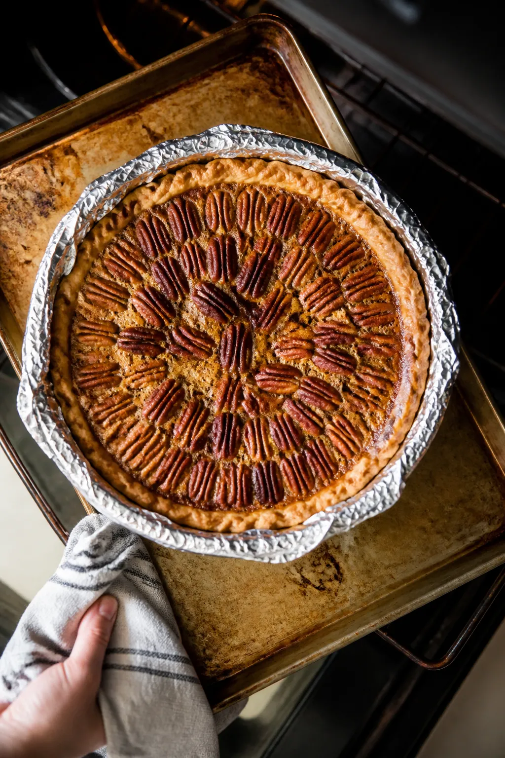 Cooking process: Overhead shot of the pie mid-bake being checked on a preheated baking sheet, golden