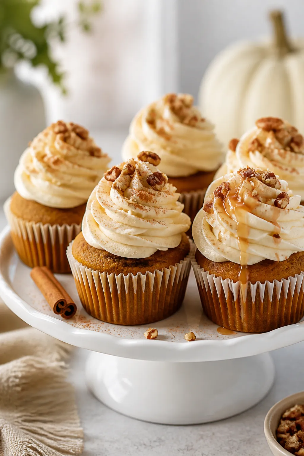 Final dish presentation: Beautifully plated pumpkin spice cupcakes crowned with tall, creamy cream c