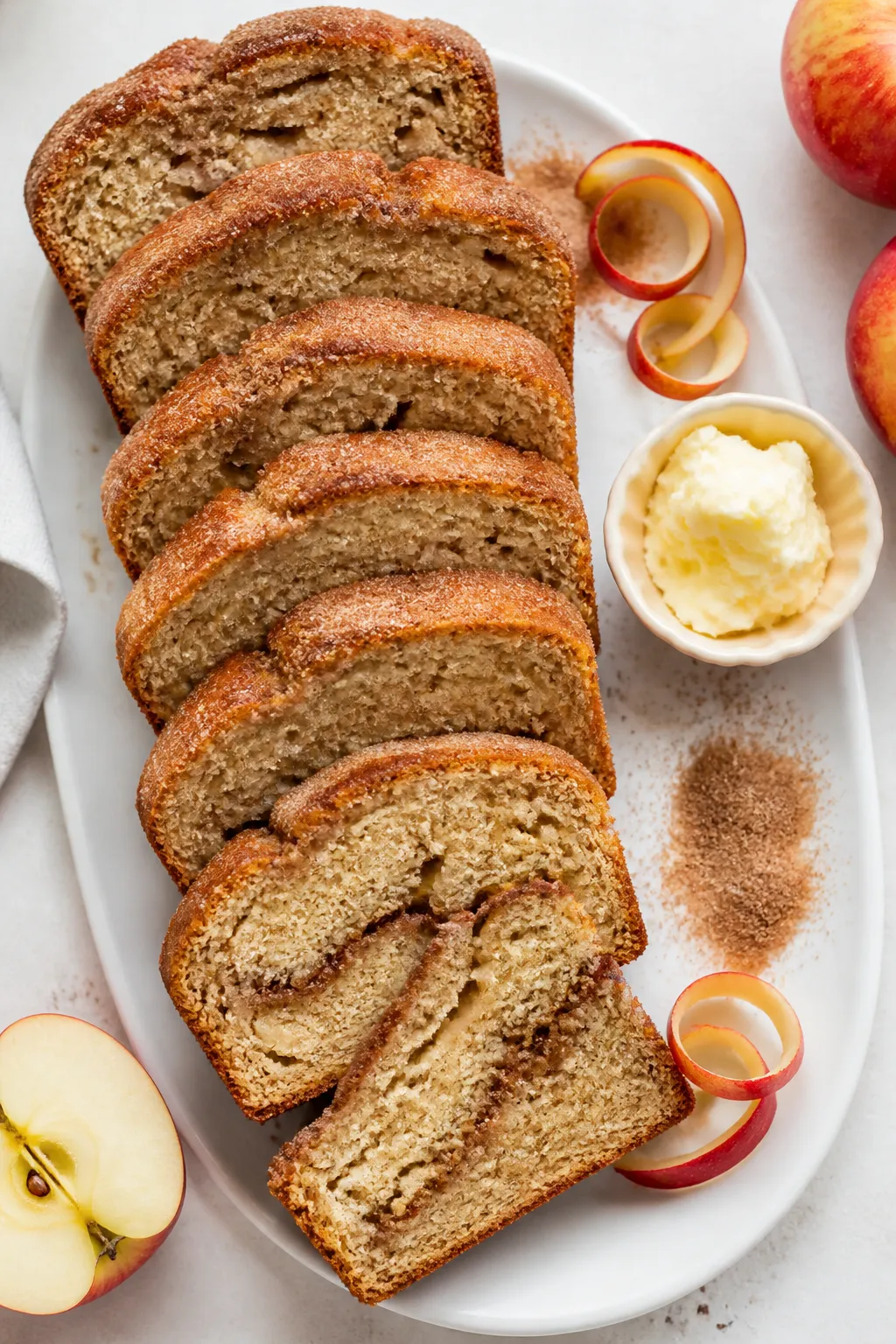 Overhead “tasty top view” of neat slices of cinnamon sugar apple bread arranged in a staggered f
