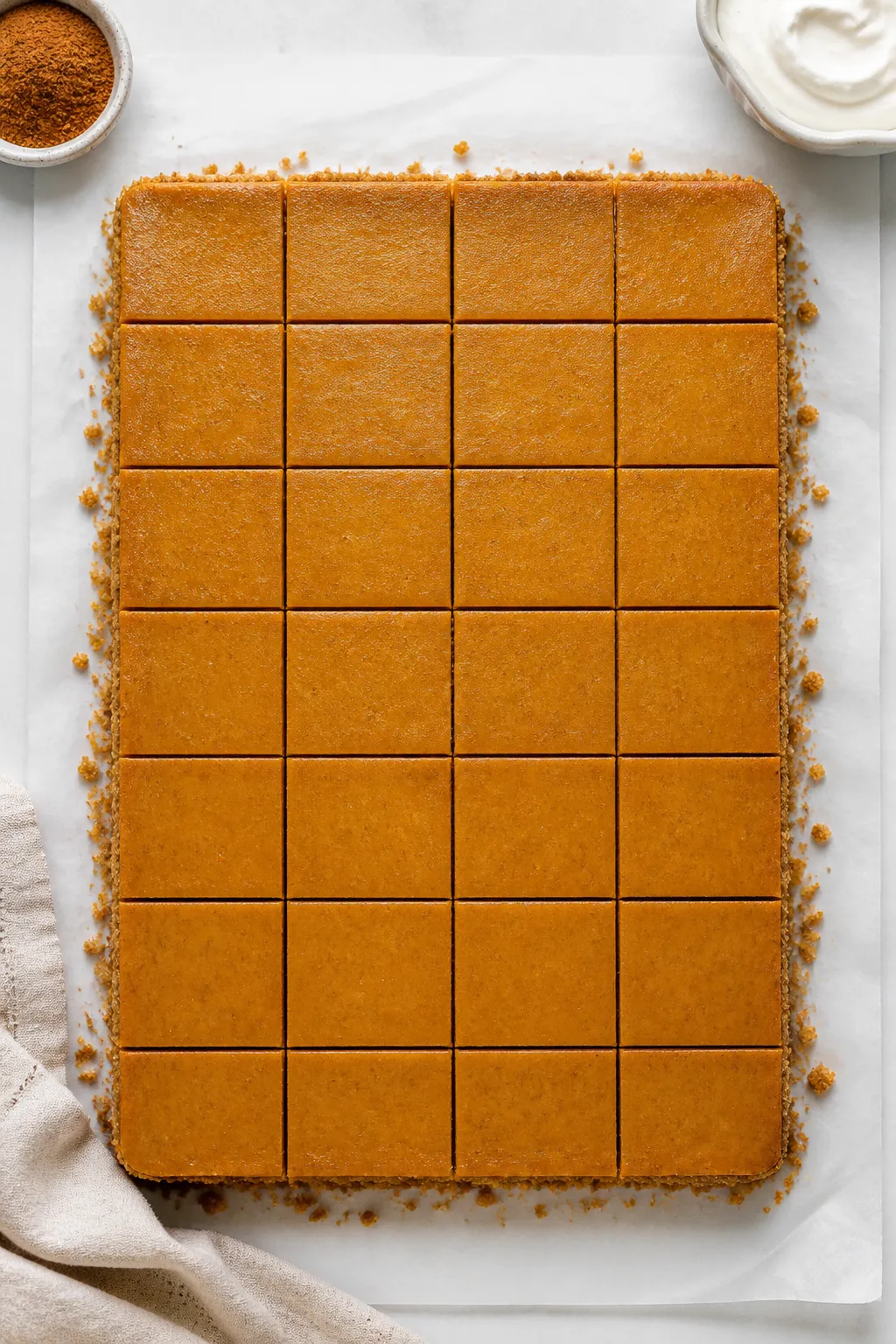 Overhead “tasty top view” of the full 9x13 slab just lifted from the pan on parchment, perfectly
