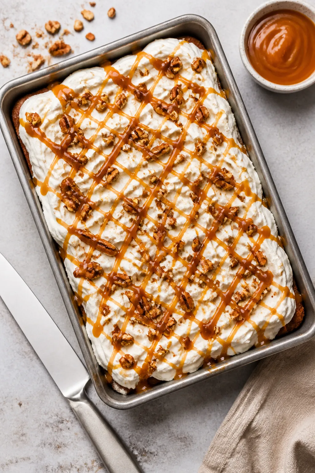 Tasty top view: Overhead shot of the fully assembled cake in the pan, topped with fluffy swirls of l