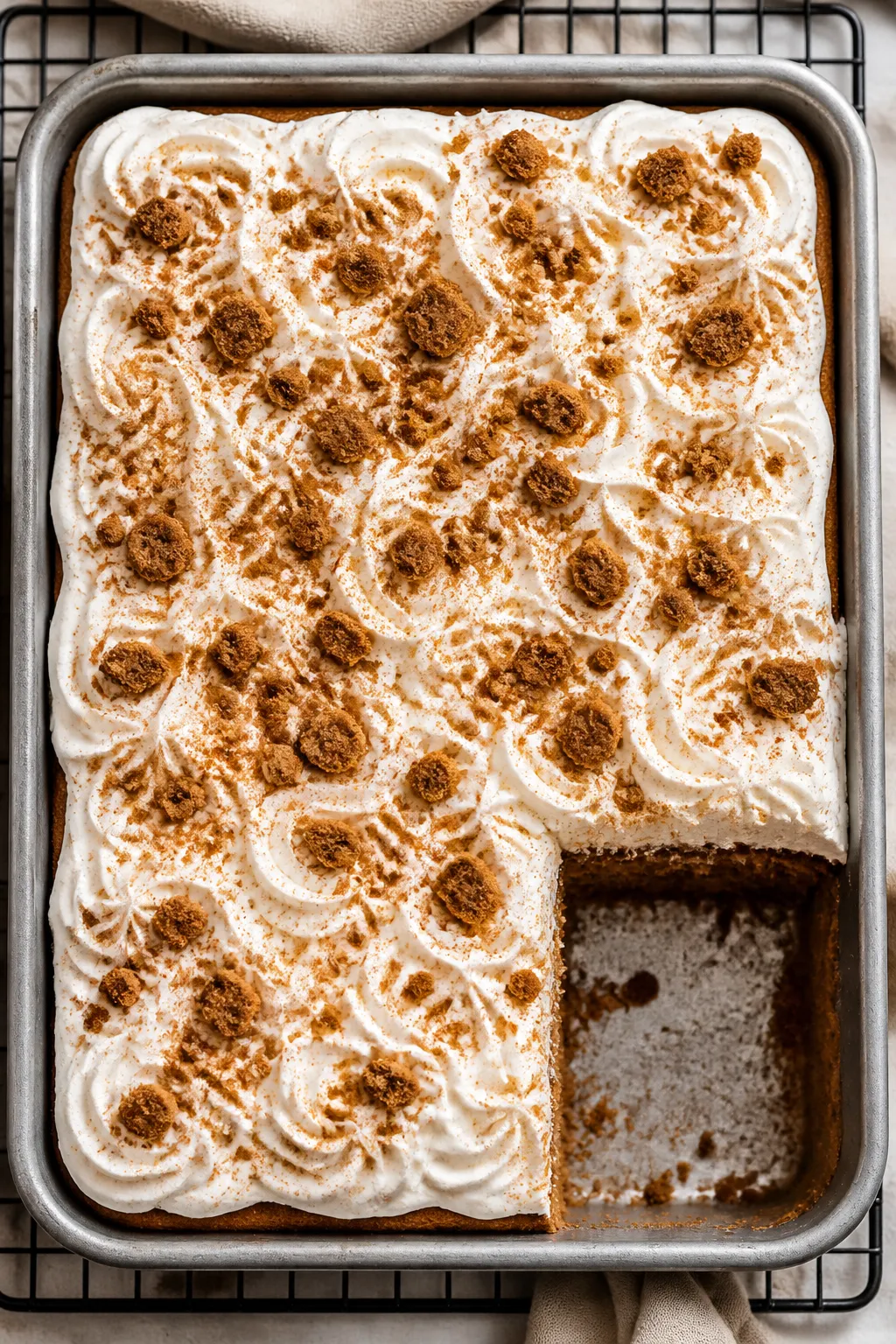 Tasty top view: Overhead shot of the fully chilled and frosted gingerbread poke cake in the pan, top