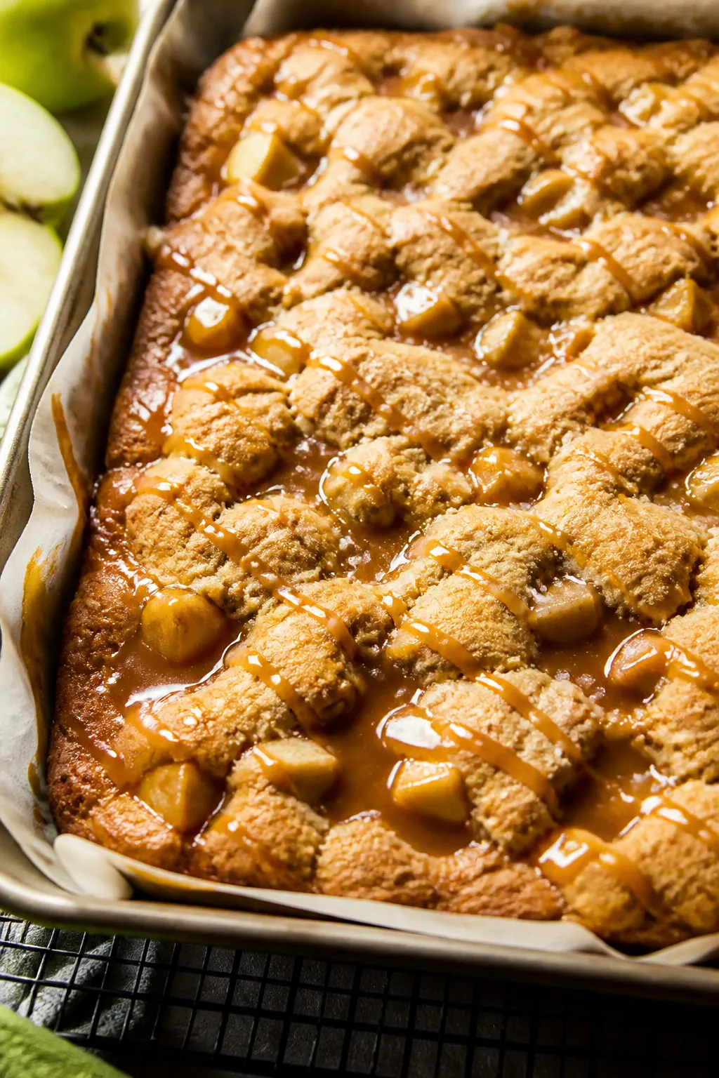 Close-up detail: A just-baked pan of Caramel Apple Cookie Bars with caramel bubbling through golden 