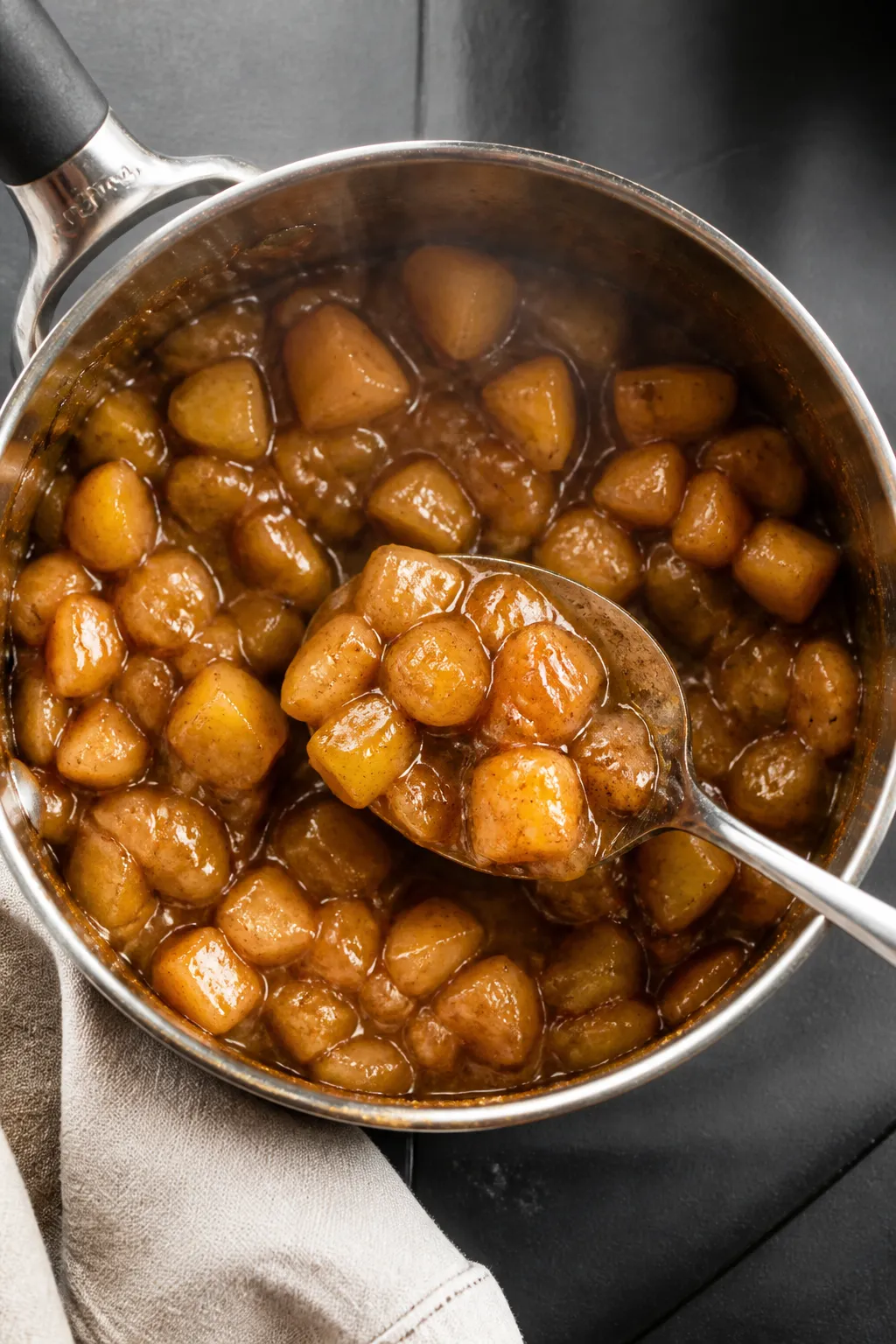 Cooking process: Overhead shot of a small saucepan filled with sautéed, cooked diced apples (Honeyc
