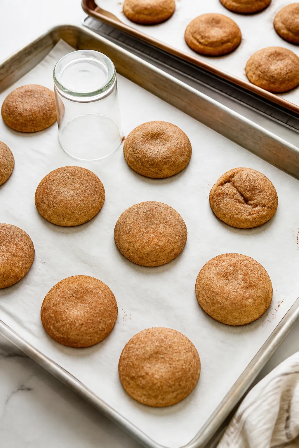 Cooking process: Overhead shot of sealed dough balls rolled in cinnamon-sugar arranged 2 inches apar