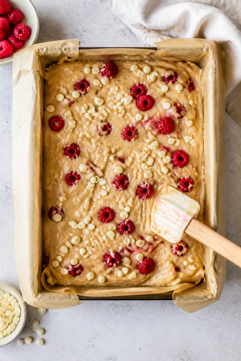 Cooking process: Overhead shot of the blondie batter being gently folded in the pan right before bak