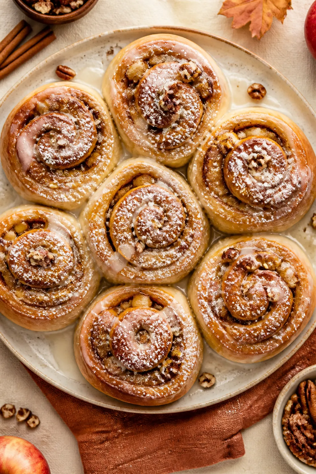 Final dish presentation: Restaurant-quality platter of baked apple pie cinnamon rolls glazed to a si