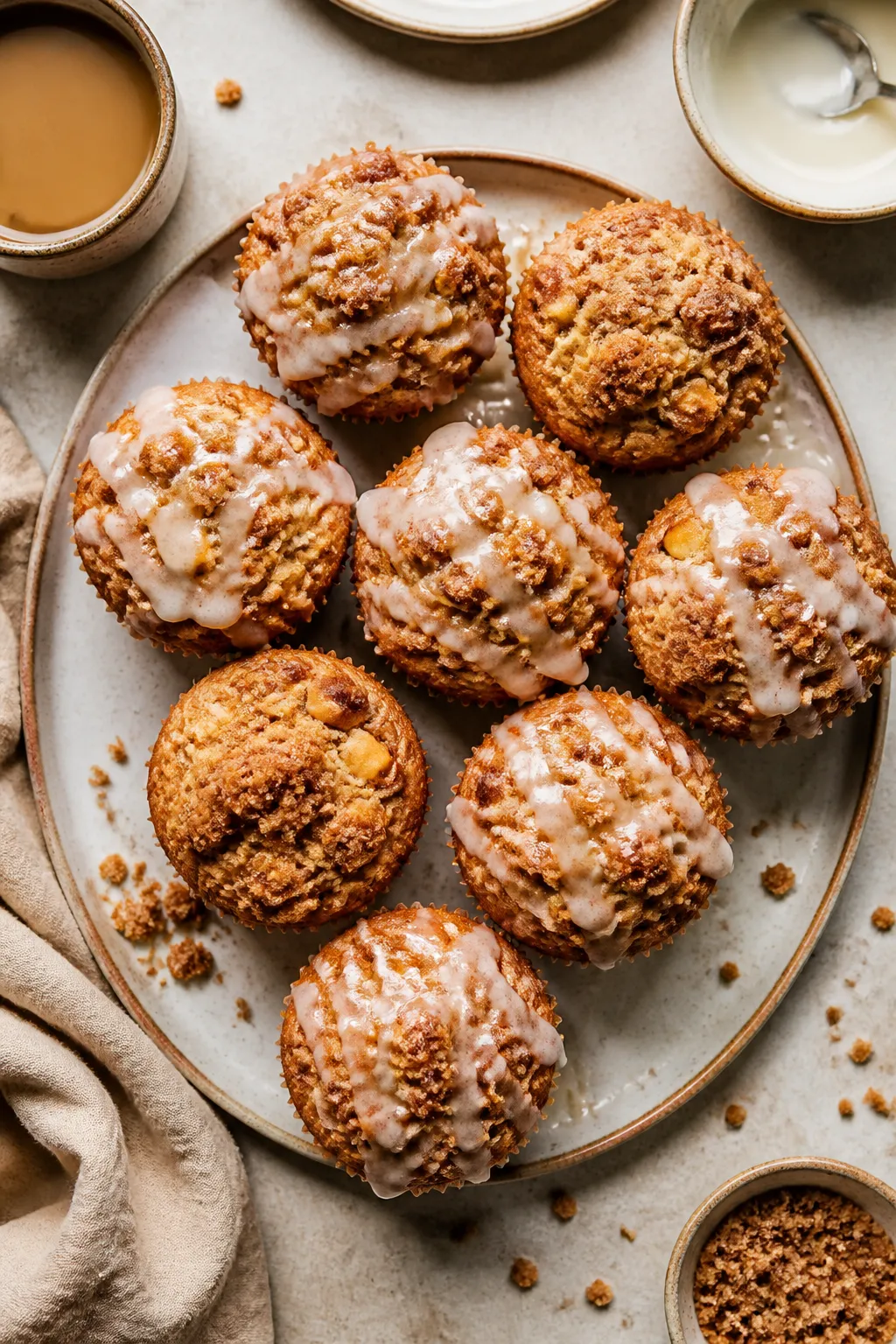 Final presentation shot: Bakery-worthy plate of apple cinnamon streusel muffins on a matte ceramic p