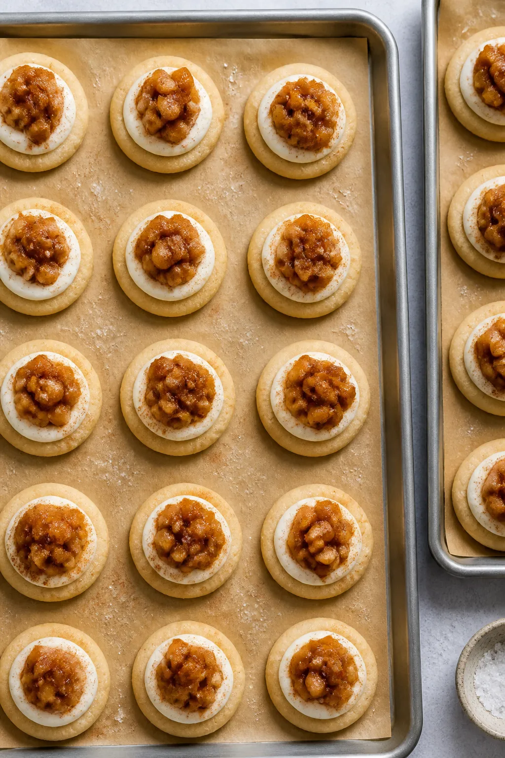 Overhead process shot: A lined baking tray of shaped cookie dough with deep wells, each neatly fille