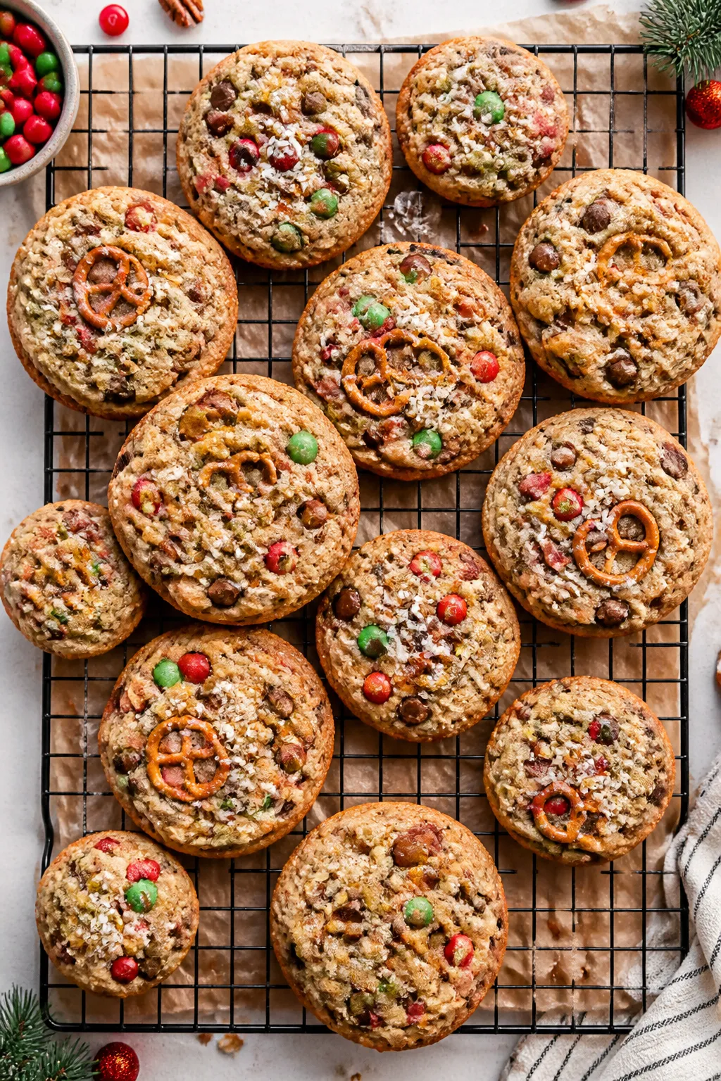 Overhead, tasty top-view of a cooling rack filled with assorted-size Christmas Kitchen Sink Cookies,