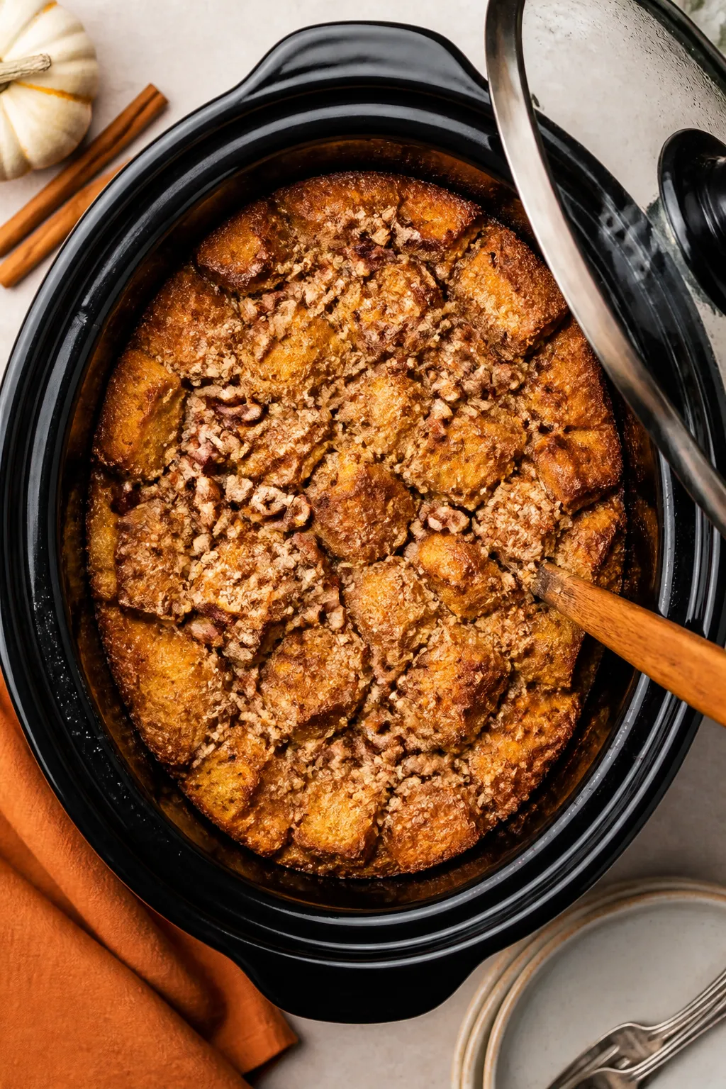 Tasty top view: Overhead shot of the entire bread pudding still in the slow cooker, evenly pressed l
